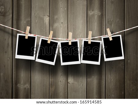 empty polaroid photos frames on wood background
