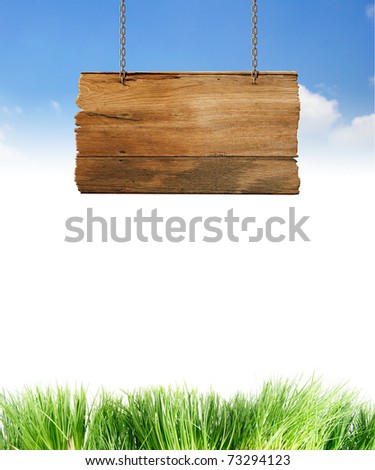 Hanging wooden sign isolated on sky.