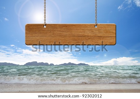 brown wooden  sign on beach
