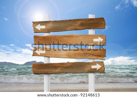 arrow wood sign on beach