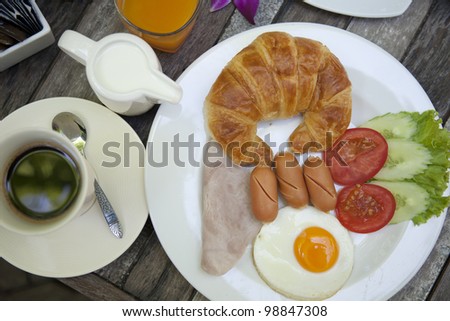American breakfast Croissant on wooden table