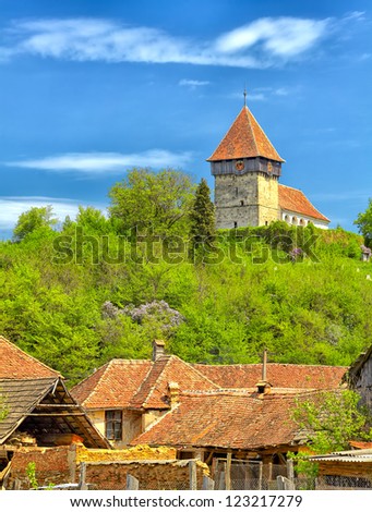 Transylvanian village of Rodbav with the church on the hill, Romania.