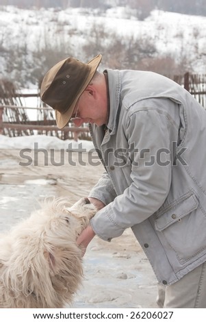Middle aged man playing with his dog