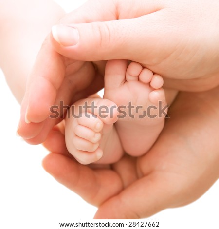 Newborn baby feet in mother\'s hands isolated on white background.