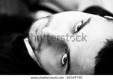 High angle view of a 20 year old man portrait, shot in studio from above.