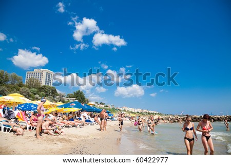 EFORIE NORD, ROMANIA - AUGUST 27: Crowded beach with tourists in summer on August 27, 2010 in Eforie Nord, Romania. Eforie is a famous summer destination for hundred of thousands of tourists a year.