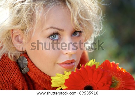 Close up portrait of a young woman outdoor with flowers.