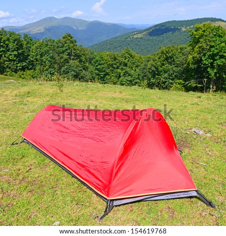 Tourist tent on a summer mountain slope.