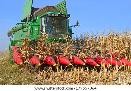 Kalush, Ukraine - OCTOBER 8: Modern John Deere combine harvesting corn  in the field near the town Kalush, Western Ukraine October 8, 2013