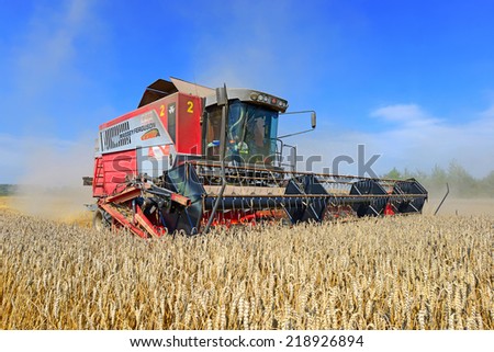Kalush, Ukraine - August 4: Modern combine harvesting grain in the field near the town Kalush, Western Ukraine August 4, 2014
