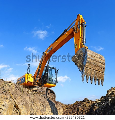 Kalush, Ukraine October 7: Modern JCB excavator on the highway pipeline performs excavation work in the field near the town Kalush, Western Ukraine October 7, 2014