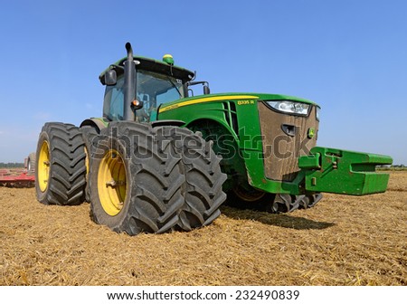 Kalush, Ukraine - AUGUST 4: Modern John Deere tractor in the field near the town Kalush, Western Ukraine AUGUST 4, 2014