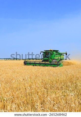 Kalush, Ukraine - July 9: Modern John Deere combine harvesting grain in the field near the town Kalush, Western Ukraine July 9, 2013