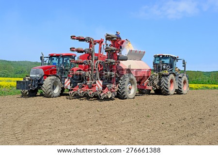Kalush, Ukraine - May 10: Load fertilizer into the hopper for sowing maize crop in the field near the town Kalush, Western Ukraine May 10, 2015
