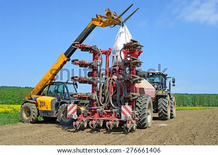 Kalush, Ukraine - May 10: Load grain into the hopper  for sowing maize crop in the field near the town Kalush, Western Ukraine May 10, 2015