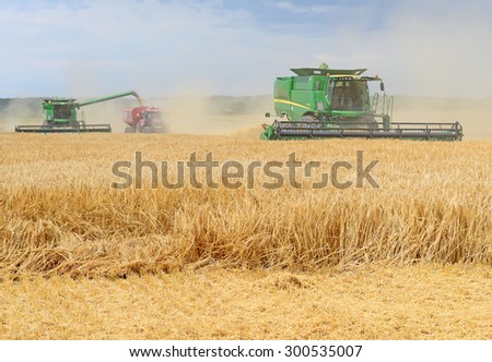 Kalush, Ukraine - July 17: Modern John Deere combine harvesting grain in the field near the town Kalush, Western Ukraine July 17, 2015