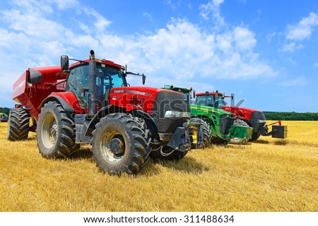 Kalush, Ukraine - July 17: Wheeleds tractors in the field near the town Kalush, Western Ukraine July 17, 2015