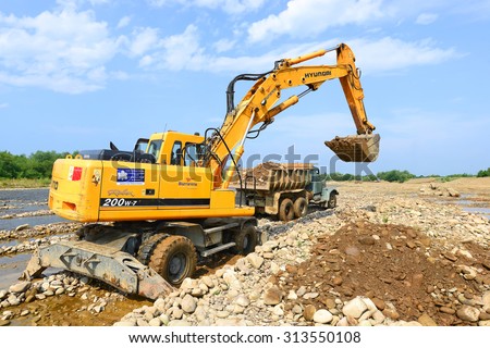 Kalush, Ukraine - July 8: Loading gravel in the car body on the construction of a protective dam near the town of Kalush, Western Ukraine July 8, 2015