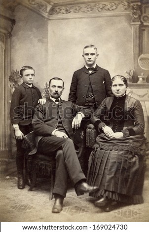 US -NEW YORK - CIRCA 1880 - A vintage antique photo of a family of four. The mother and father are sitting with their sons standing behind them. A photo is from the Victorian era. CIRCA 1880
