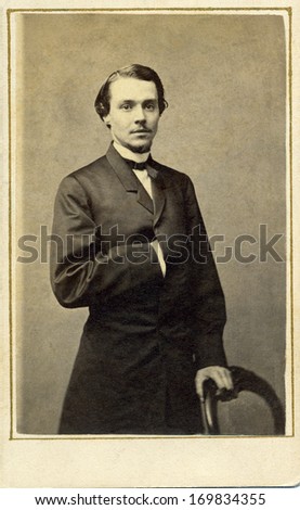 Usa - New York - Circa 1863 - A Vintage Cartes De Visite Photo Of A Young Gentleman. The Man Is Standing With One Arm Inserted Into His Coat. A Photo From The Civil War Era. Circa 1863