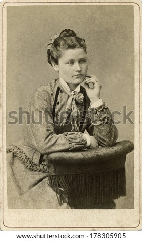 EUROPE - SWEDEN - CIRCA 1875 - A vintage Cartes de visite photo of young woman sitting dressed in Victorian style dress with fancy collar. Photo from the Victorian era. CIRCA 1875