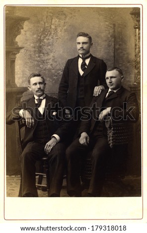 USA - PENNSYLVANIA - CIRCA 1890 A vintage Cabinet Card photo of three young men. Two of the men have mustaches. They are dressed in Victorian style clothing. Photo is from the Victorian era CIRCA 1890