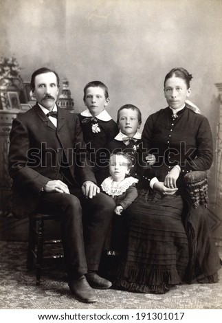USA - WISCONSIN - CIRCA 1885 A vintage photo of a Victorian family. The parents are sitting with three small children. The father has a mustache. This photo is from the Victorian era. CIRCA 1885