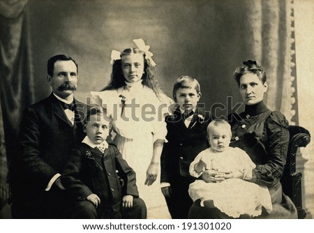USA - MINNESOTA - CIRCA 1890 A vintage photo of a Victorian family. The parents are sitting with four children. The father has a mustache. This photo is from the Victorian era. CIRCA 1890