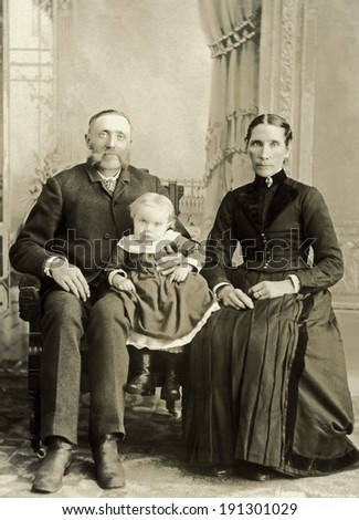 USA - NORTH DAKOTA - CIRCA 1895 A vintage photo of a Victorian family. The parents or grandparents are older with a small child. The man has a mustache. Photo is from the Victorian era. CIRCA 1895
