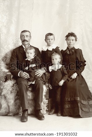 USA - MINNESOTA - CIRCA 1895 A vintage photo of a Victorian family. The parents are sitting with three small children. The father has a mustache. This photo is from the Victorian era. CIRCA 1895