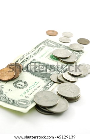 An American one dollar bill and several different American coins isolated on a white background.