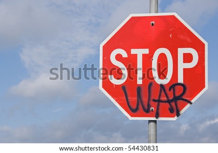 Freedom of speech with the word war painted on a stop sign at an intersection of a road