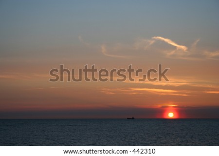 Sunset with a ship and corona over the sun.