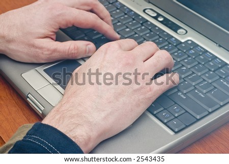 closeup of hands typing on a laptop