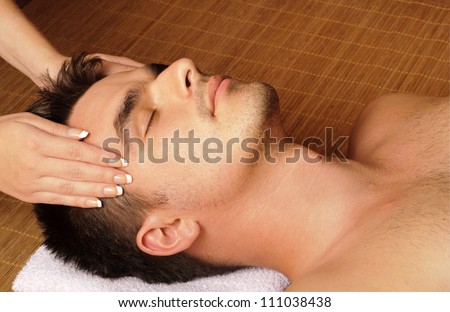 Man getting a facial / face massage at day spa