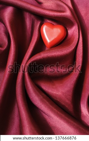 Small heart on a satin sheet