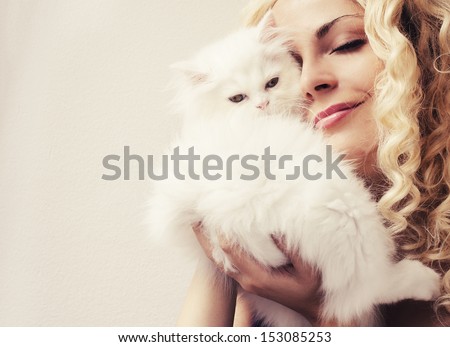 Beautiful woman golding fluffy white Persian kitten
