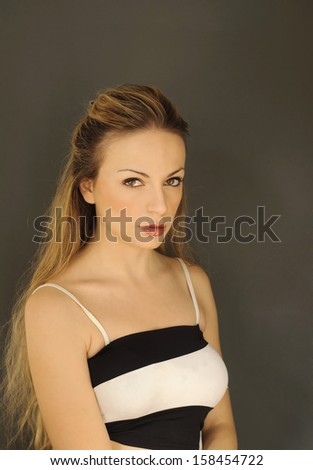Beautiful young woman with serious facial expression