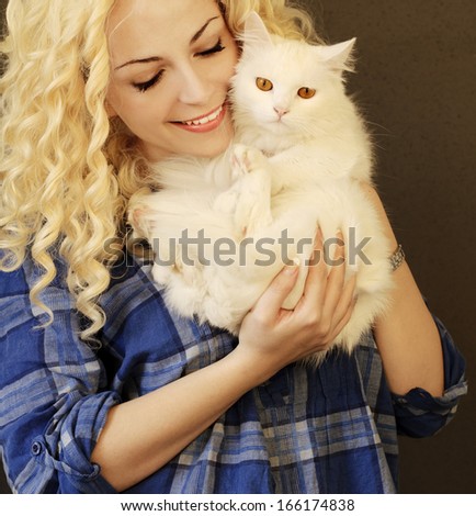 Beautiful young woman holding white Persian cat