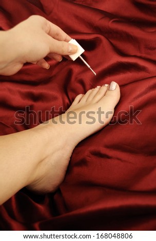 Woman painting toe nails