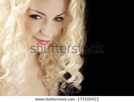 Pretty woman with curly blond hair isolated on black