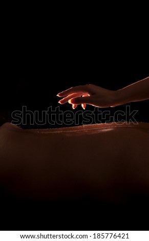Woman about to touch a man\'s back, back massage
