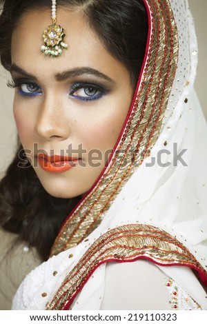 portrait of a beautiful Indian bride wearing traditional eastern outfit.