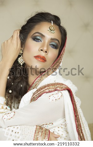 portrait of a beautiful Indian bride wearing traditional eastern outfit.