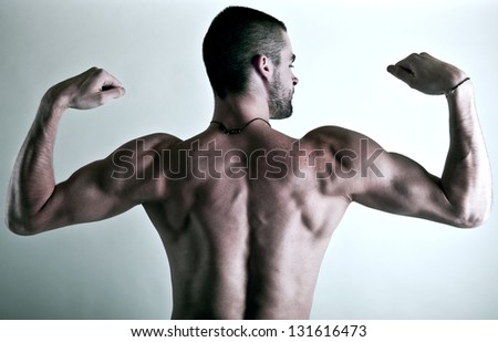 muscular young man back isolated on silver background