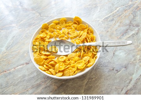 bowl of cereal with milk on stone background