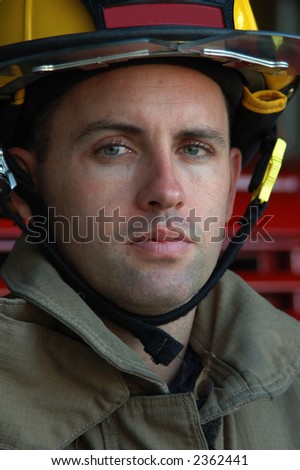 Vertical close-up of a firefighter in his gear