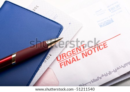 Close up of check book over a business mail labeled \