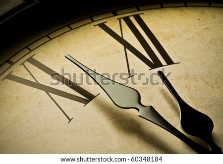 Close up of an antique clock and the time is almost midnight. Concept of time,the past or deadline.