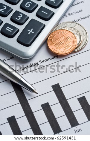 Calculator, coins and pen laying on credit card report.  Concept of finance.